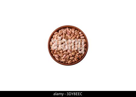 Salted pistachios in shells as a healthy, high calorie food ingredient. Pistachios as a food background for your design Stock Photo