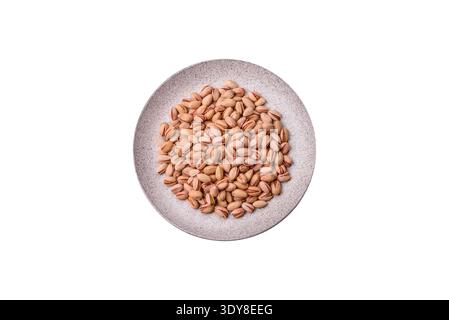 Salted pistachios in shells as a healthy, high calorie food ingredient. Pistachios as a food background for your design Stock Photo