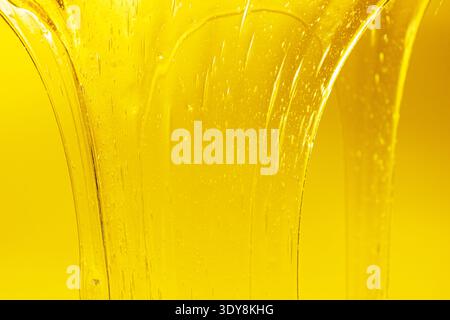 Flowing golden honey with air bubbles texture Stock Photo