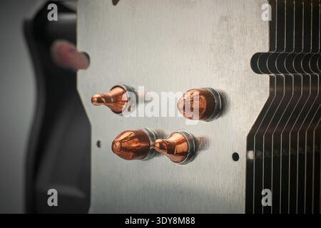 brushed silver metal fins and copper heat pipes of cpu cooler, computer hardware component, pc building background concept, closeup soft focus Stock Photo