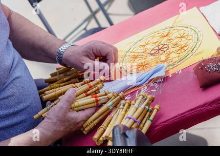 bobbin lace, textile technique, considered as a craft, which consists of interweaving threads that are initially wound on bobbins, called bobbins, to Stock Photo