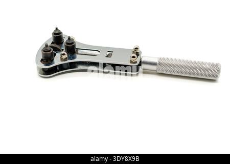 Watch case back opener tool with adjustable pins and knurled metal handle, isolated on white background. Stock Photo