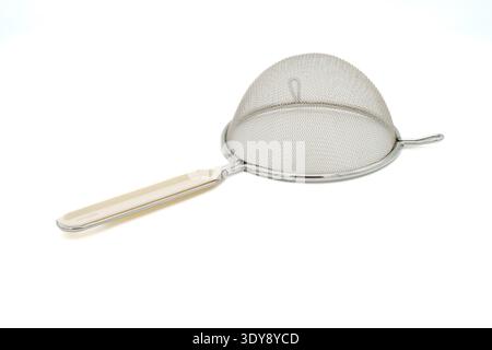 Stainless steel mesh strainer with cream-colored handle, isolated on white background Stock Photo
