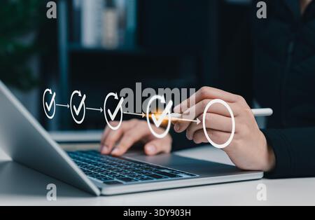 Project planning and workflow management concept. Person using laptop with virtual checklist and progress icons, represent task tracking, business Stock Photo