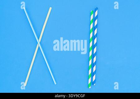 Plastic straw. Plastic pollution is harmful to marine life. Environmental concept. Ban single-use plastic campaign. Use of recyclable cardboard straw. Stock Photo