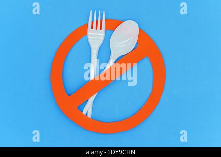 Fork and spoon on prohibition sign. Concept not to use single-use plastics. Top wiew. Copy space Stock Photo