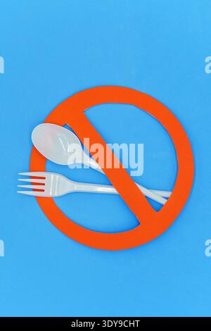 Fork and spoon on prohibition sign. Concept not to use single-use plastics. Top wiew. Copy space Stock Photo