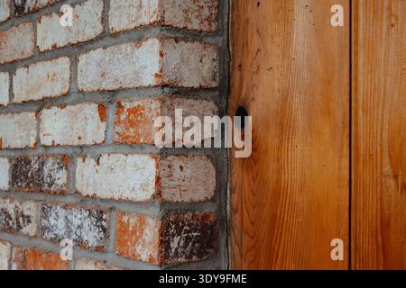Textures of brick next to a wooden wall in a cabin Stock Photo