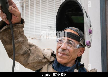 Experienced man demonstrating confidence and professionalism in protective workwear Stock Photo