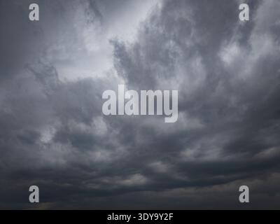 Dramatic close-up of dark, heavy storm clouds filling the sky before a rain. High texture, moody atmosphere Stock Photo
