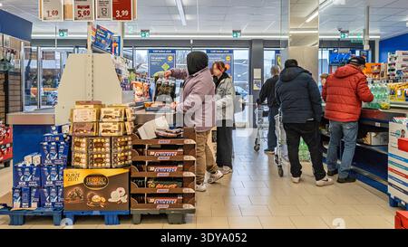 23 February 2026, Hamburg: Customers are standing in the checkout area of a supermarket. Photo: Markus Scholz/dpa Stock Photo