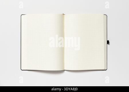 Open notepad on a white background. The page is blank. Stock Photo