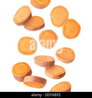 Sweet potato pieces falling against white background Stock Photo