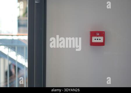 Fire alarm is installed on the wall in a building hallway Stock Photo