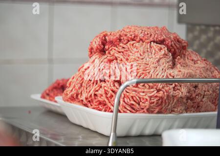 Ground meat on a white tray in a kitchen area Stock Photo