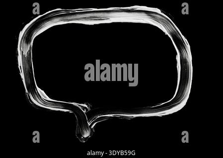 A textured white chalk doodle of a rounded rectangular frame or speech bubble on a black chalkboard background for creative layouts. Stock Photo
