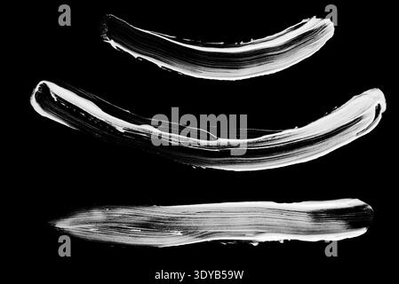 Set of textured white chalk curved lines, arched strokes, and underlines for emphasizing text on a black background. Stock Photo