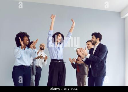Office Team Celebrating Success, Applauding And Dancing Stock Photo