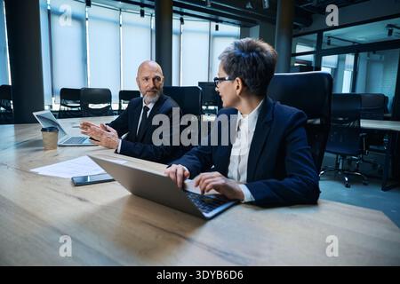 Business meeting between male and female professionals in office Stock Photo