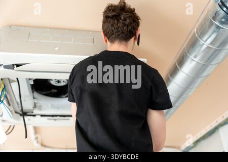 Hvac technician installing air conditioning unit maintenance work Stock Photo