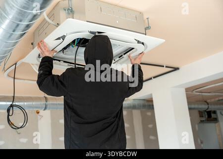 Hvac technician installing air conditioning system Stock Photo