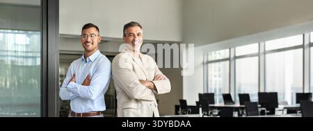 Portrait of two happy business men executive team standing in office. Stock Photo