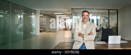 Confident happy middle aged businessman ceo executive leader in office. Portrait Stock Photo