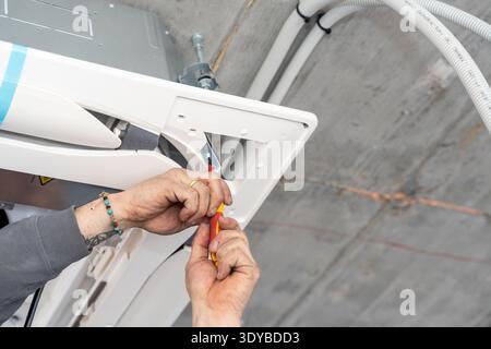 Hvac technician installing air conditioner unit indoors Stock Photo