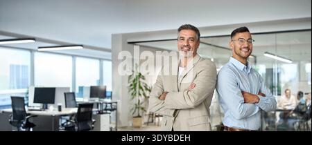 Two confident business men leaders standing back to back in office. Portrait. Stock Photo