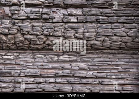 Burnt wood surface creating a detailed texture, showing damage and charcoal patterns from fire Stock Photo