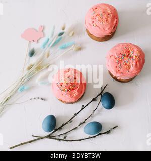 Easter Cake and Pastries, Blue Eggs and willow branches.Traditional Easter powdered sugar pastries, blue marbled eggs, delicate flowers, symbolizing Stock Photo