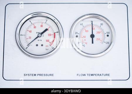 Industrial instrument panel with pressure and temperature gauges, clear dial markings and needle pointers for system performance monitoring, reliabili Stock Photo