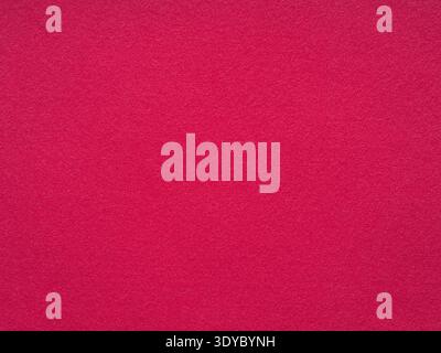 A vibrant magenta felt surface exudes a warm and tactile aesthetic Stock Photo