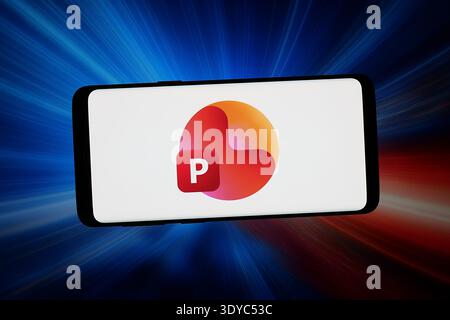 In this photo illustration, the logo of presentation software Microsoft PowerPoint is seen displayed on a smartphone in front of an abstract background on a computer screen. Stock Photo