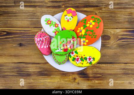 Egg shaped easter gingerbread cookies on wooden table. Top view. Sweets for celebrate Easter Stock Photo