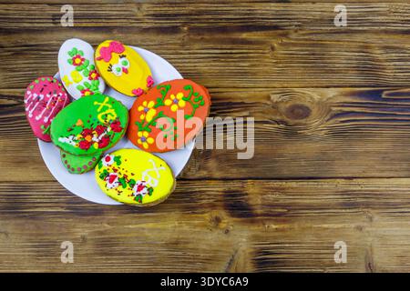 Egg shaped easter gingerbread cookies on wooden table. Top view. Sweets for celebrate Easter Stock Photo