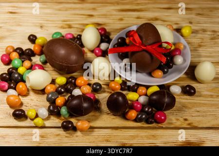 Easter composition with chocolate eggs on wooden background Stock Photo