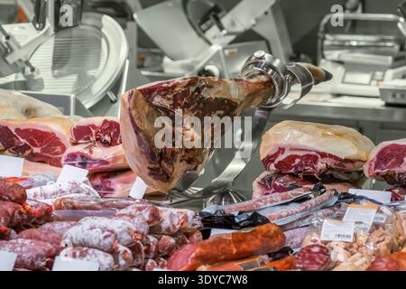 Traditional Spanish jamon ham presented at a local food market stall Stock Photo