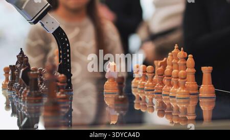 Robot arm playing chess with artificial intelligence and advanced automation Stock Photo