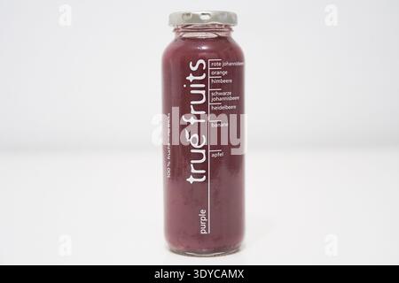 True Fruits smoothie, bought at Edeka, purple, red currant, orange, raspberry, black currant, blueberry, berries, banana, apple, mixed, in glass bottl Stock Photo