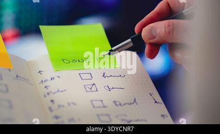 Checklist notebook completed task sticky note DONE. Hand marking finished activity task list productivity progress confirmation planning workflow orga Stock Photo
