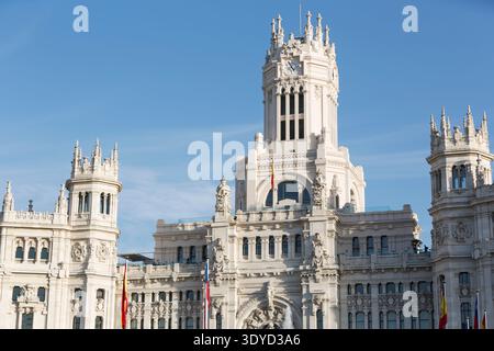 The ornate white facade and central clock tower of the Palacio de Cibeles, Madrid City Hall, Spain. Stock Photo