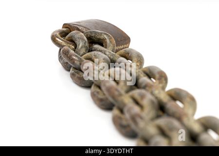 This image captures a close-up of a rusted chain linked with a heavy-duty padlock, resting on a stark white background, symbolizing strength and resil Stock Photo