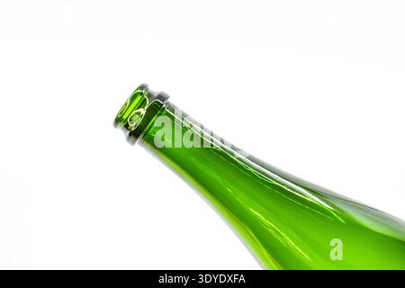 Close up view of the neck of an empty green wine bottle isolated on a plain white background Stock Photo