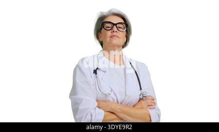 Mature doctor with stethoscope standing with arms crossed Stock Photo