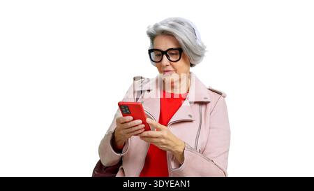 Senior woman using phone and listening music Stock Photo