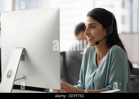 Brazilian woman call center worker in headset talking via videocall Stock Photo