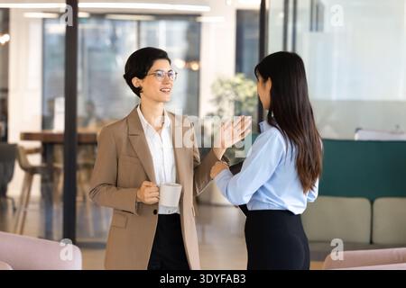Diverse businesswomen colleagues talking during break in office Stock Photo