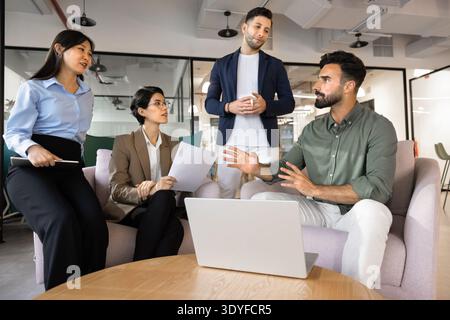 Team leader explaining corporate strategy to diverse colleagues Stock Photo