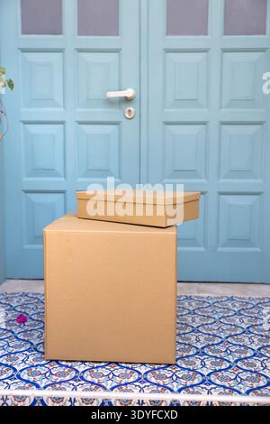 Closeup of two cardboard boxes placed on residential house porch Stock Photo